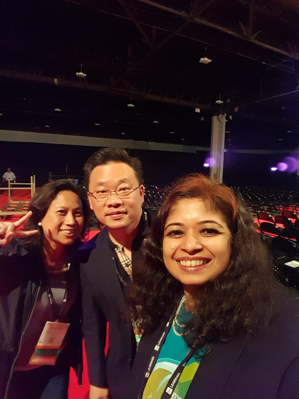 Geetha Krishnan with fellow attendees in an event auditorium